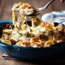 Close up of melted cheese on top of vegetable pasta bake.