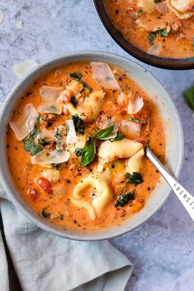 Close up bowl of soup with tortellini.