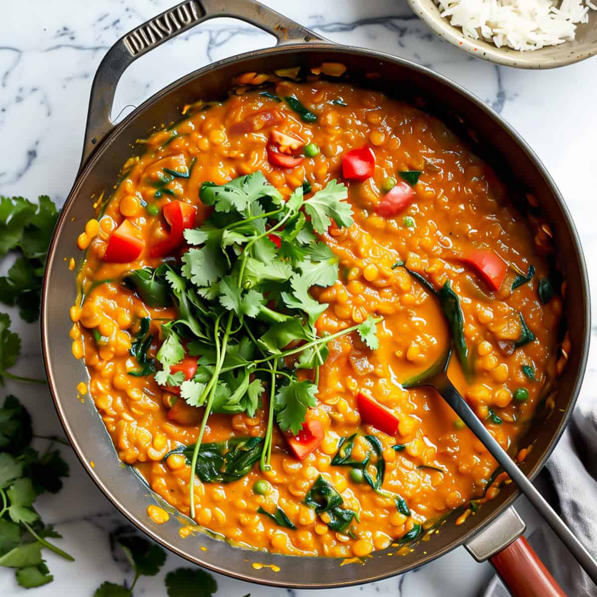 Red lentil dhal curry with tomatoes and spinach.