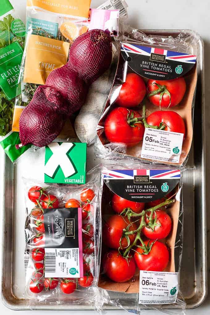 Ingredients for roasted tomato soup on a table.