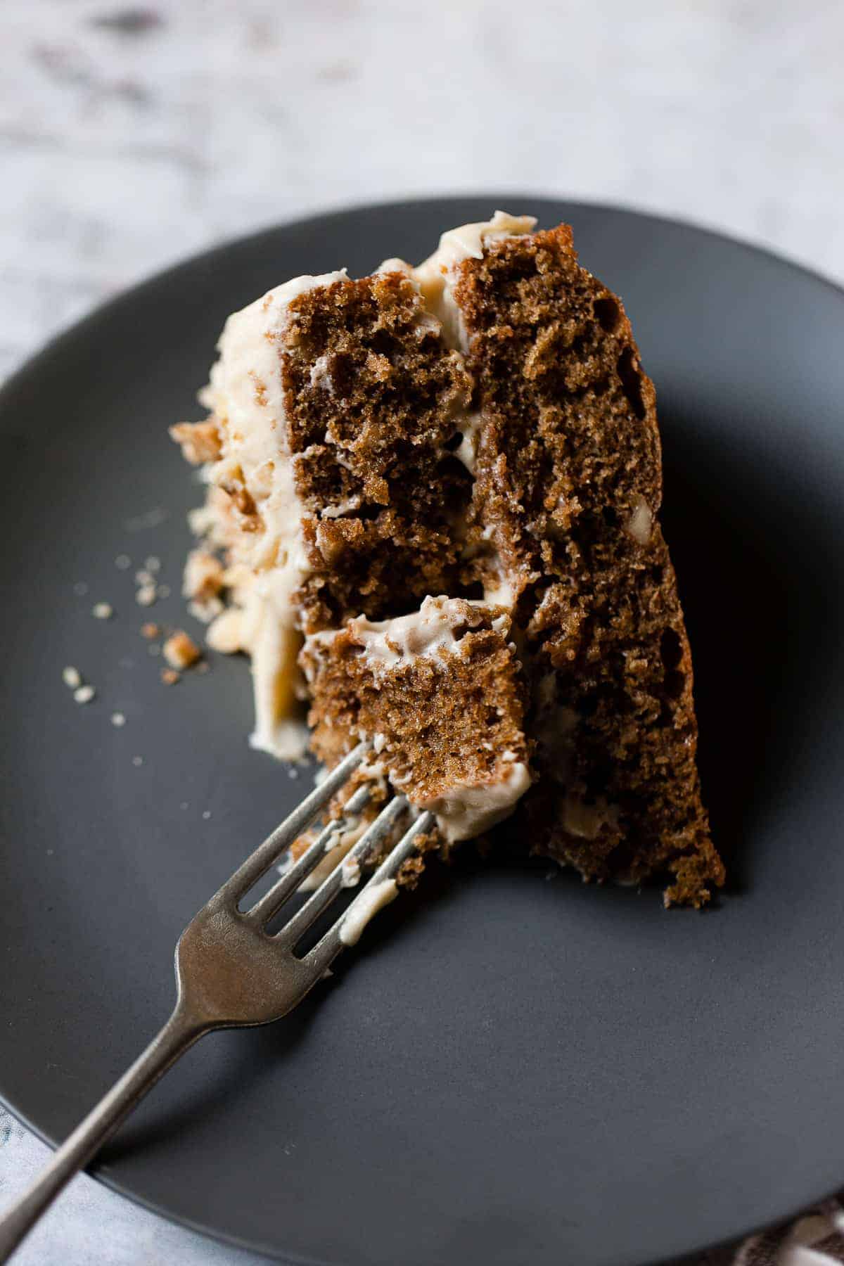 Slice of coffee walnut cake on a black plate. All ingredients from Aldi. 