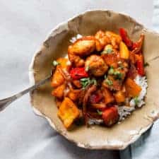 Bowl of sweet and sour chicken with rice.