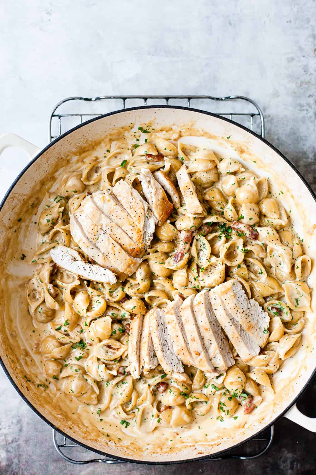 easy chicken and bacon pasta in a white pot.