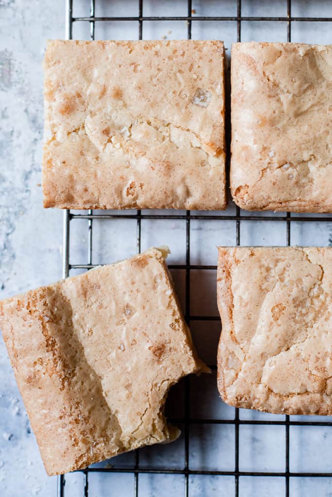 easy white chocolate blondies on a cooling rack with sea salt.
