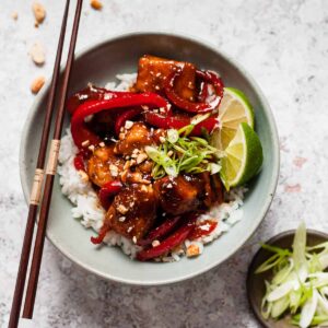Sticky chicken using Aldi ingredients on a white table.