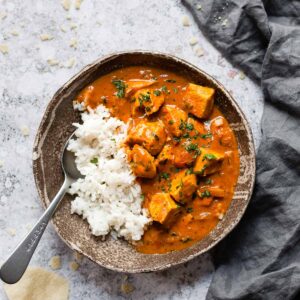 Easy coconut chicken curry in a brown bowl.