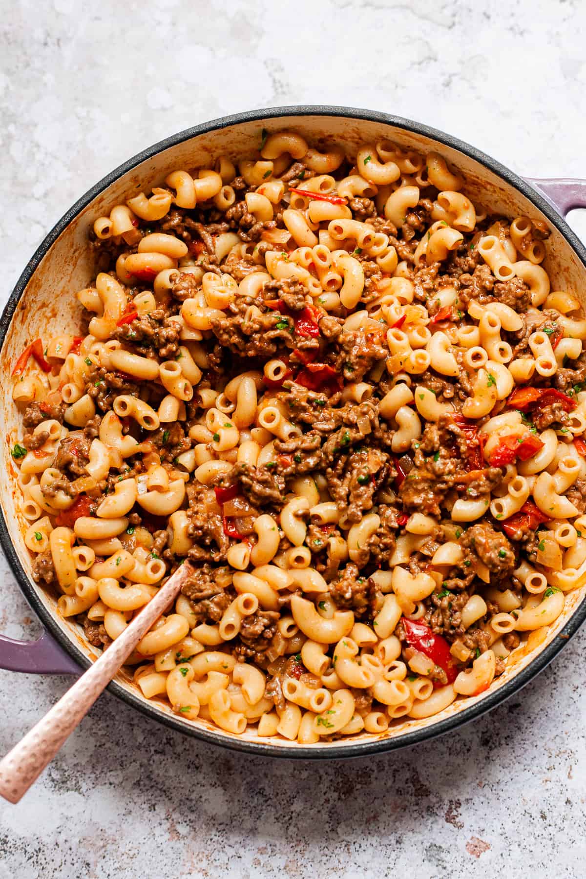 Cheeseburger pasta with macaroni in a skillet on a table.
