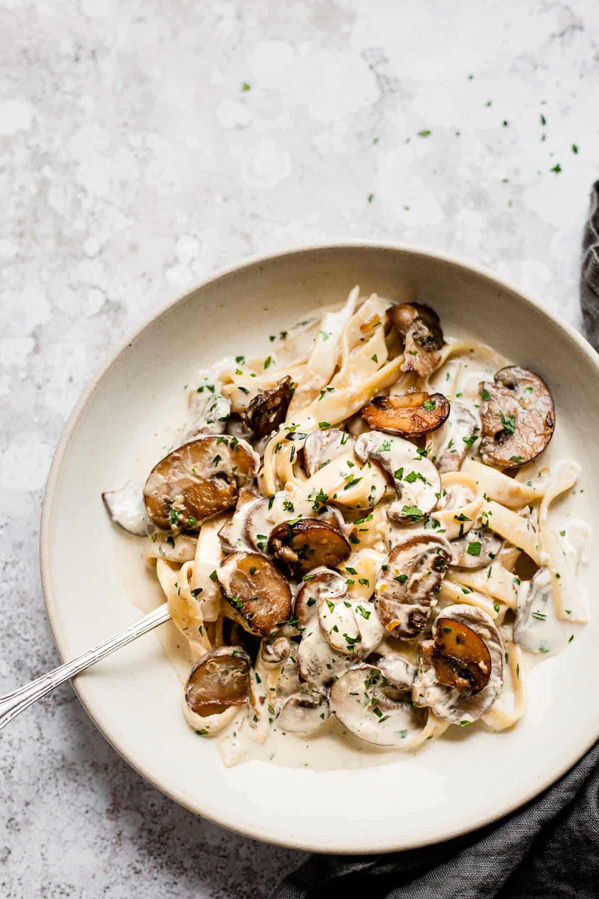 mushroom tagliatelle in garlic sauce in a white bowl. All Aldi ingredients.