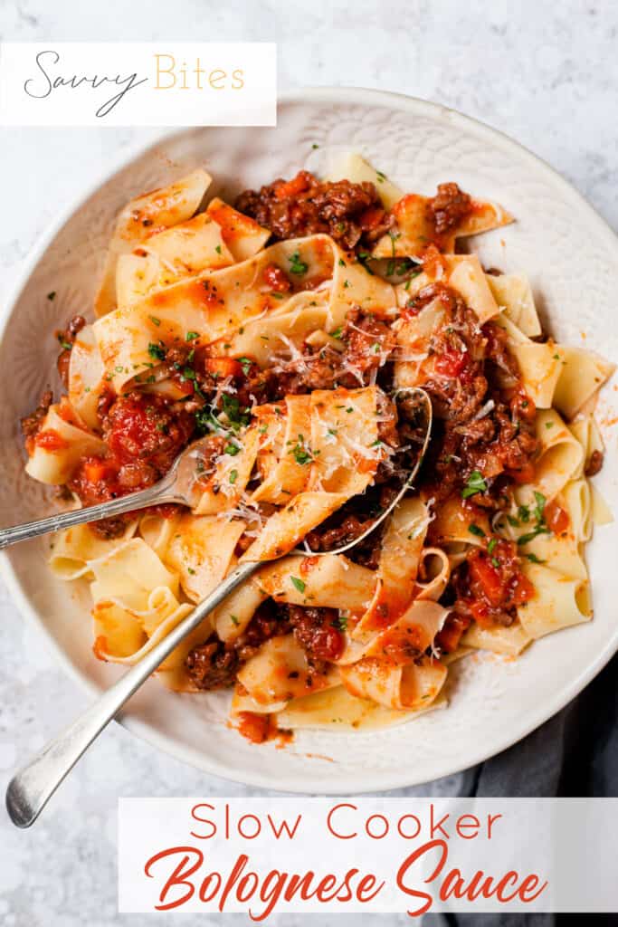 slow cooker bolognese in a white bowl with a fork. Text overlay.