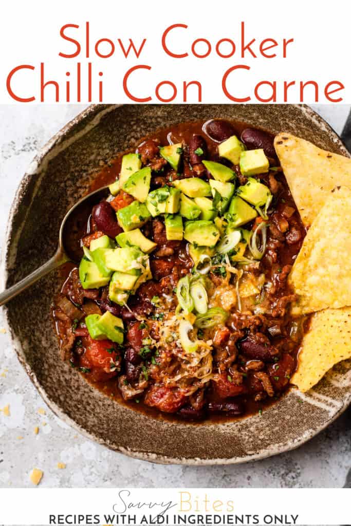 slow cooker chilli in a bowl with tortilla chips. Text overlay.