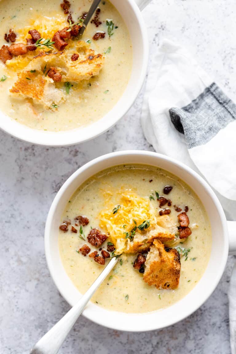 cauliflower cheese soup in white bowls.