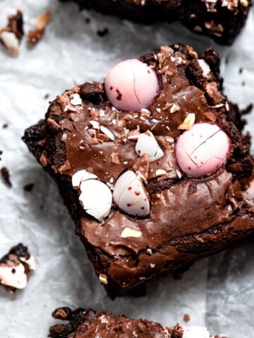 Mini egg brownies on a baking tray with parchment paper.