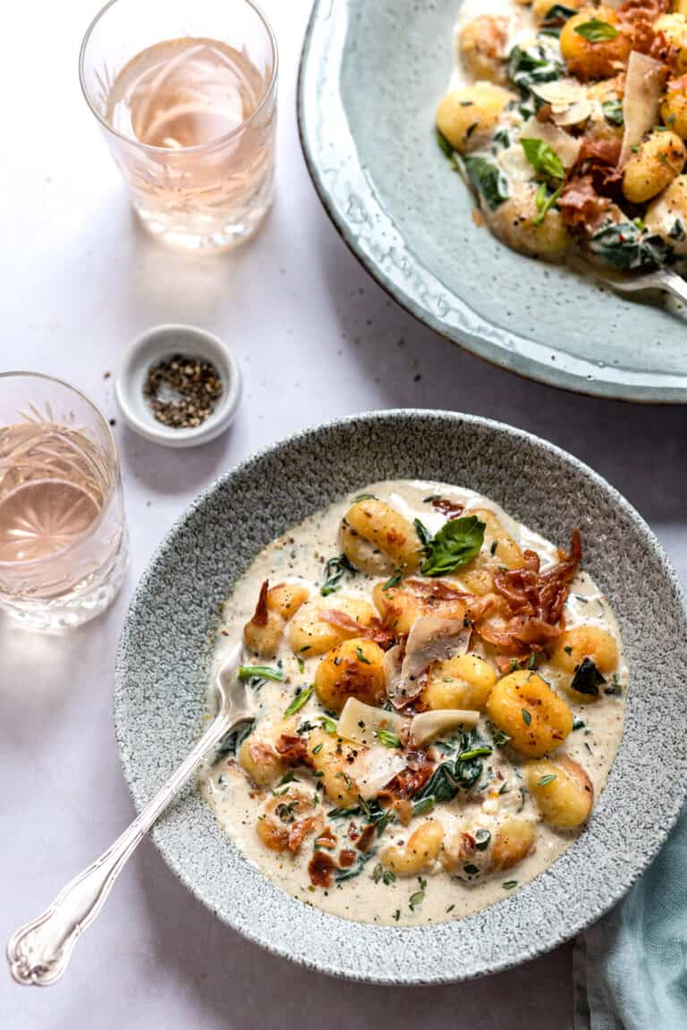 spinach gnocchi in a green bowl