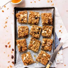 Healthy flapjacks on a baking tray with honey.