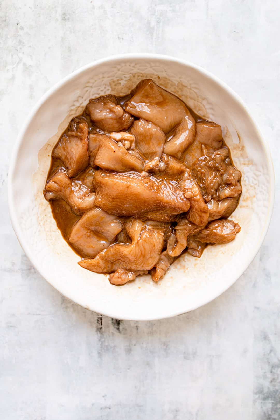 Marinating chicken for chilli chicken.