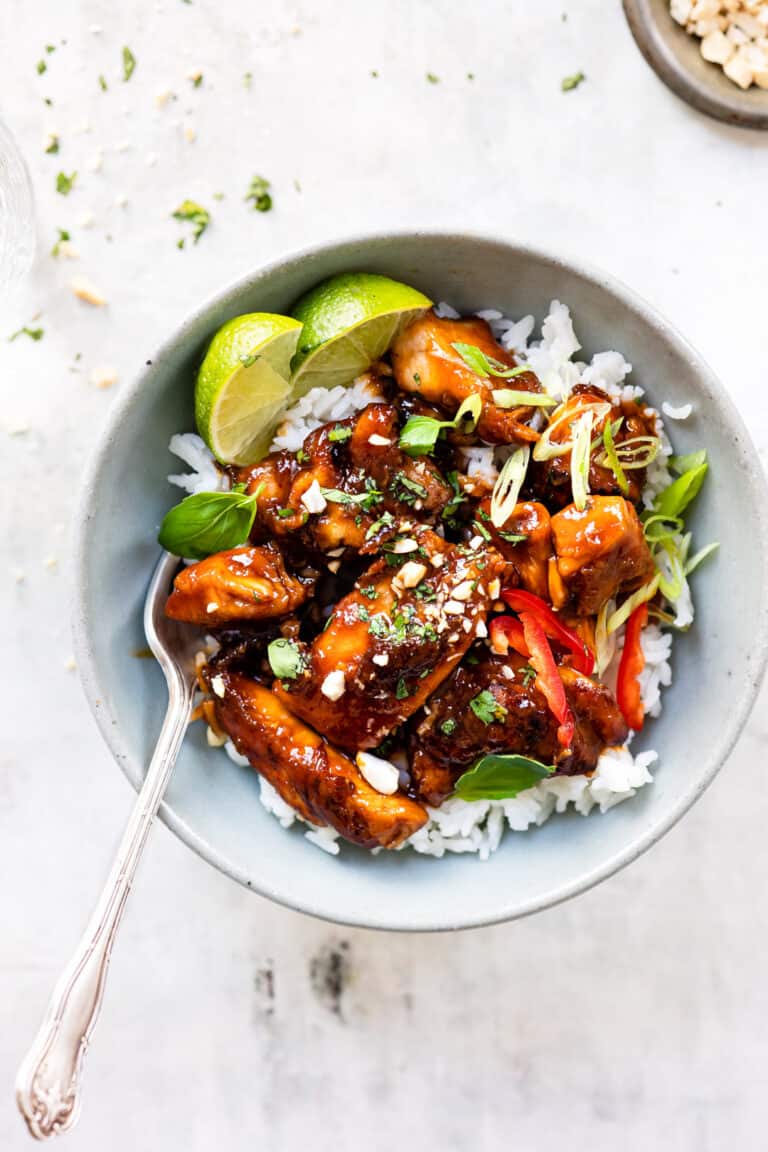 Easy crispy chilli chicken in a blue bowl on a bed of rice.