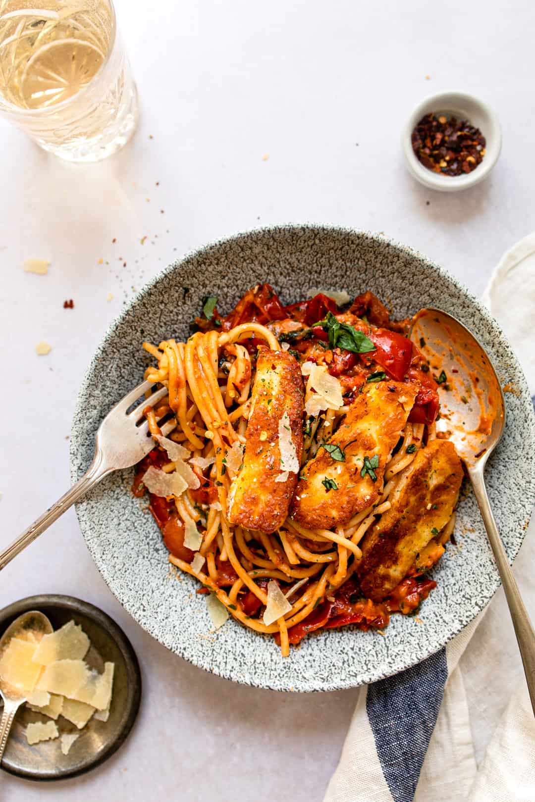 Halloumi pasta in a bowl with parmesan cheese.