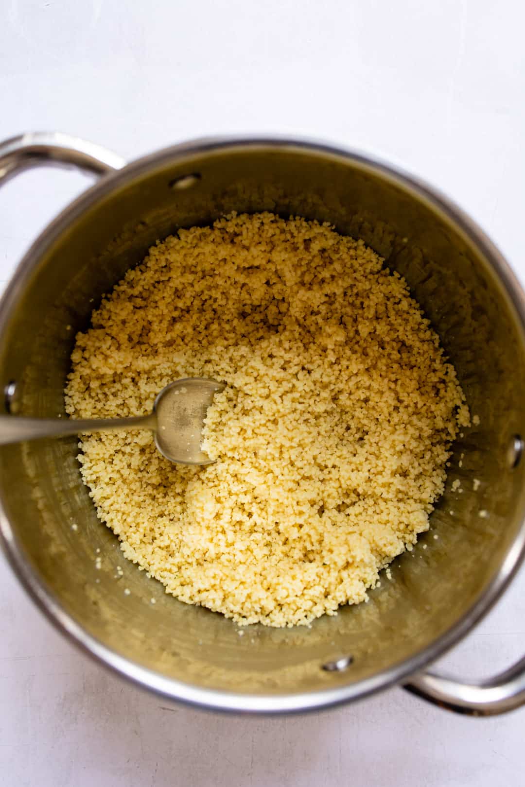 Couscous fluffed with a fork.