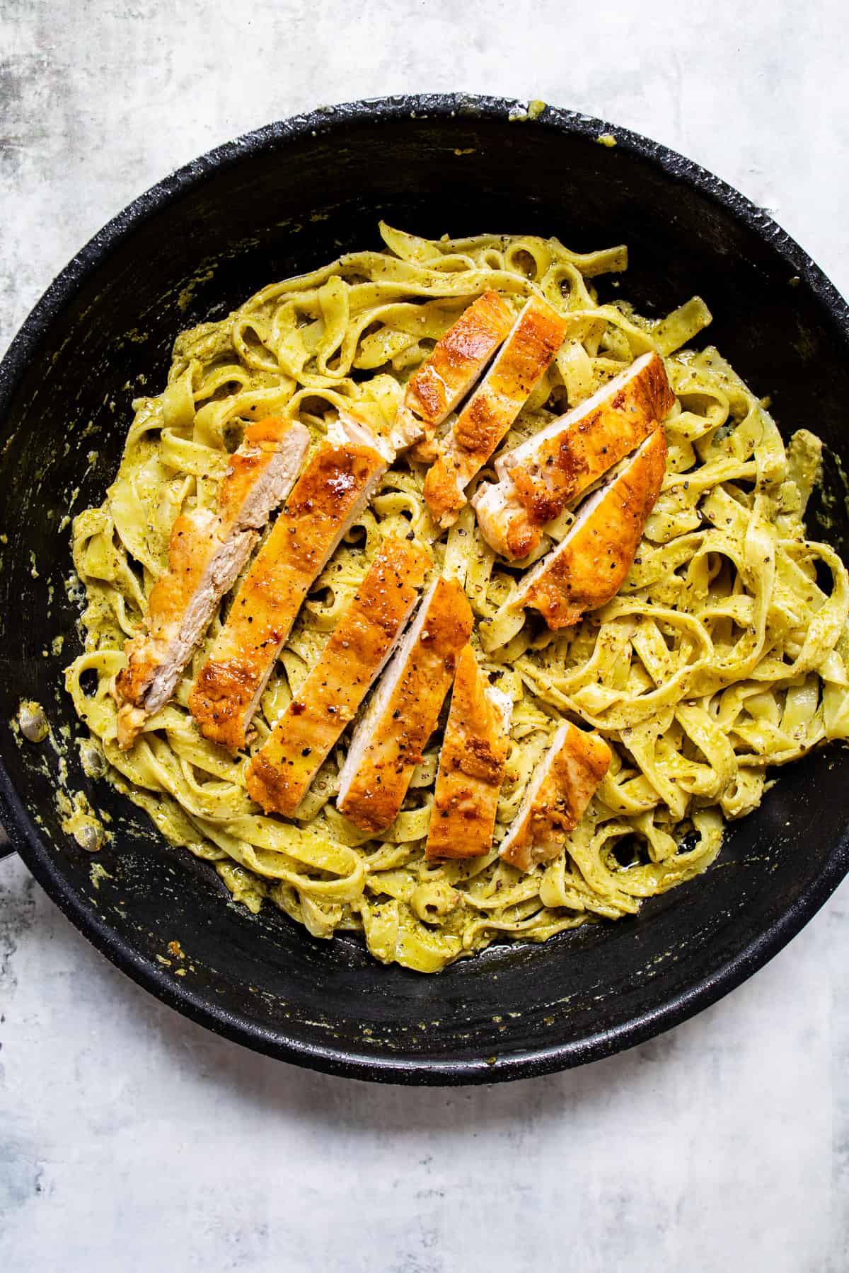 fried chicken over pesto pasta