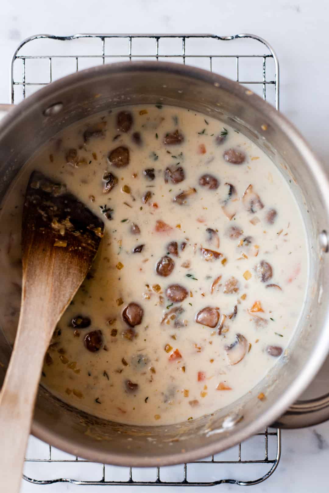 Mushrooms in creamy sauce in a pan.