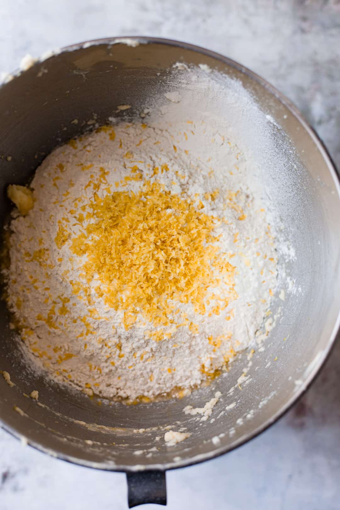 Lemon zest being mixed into cake batter.