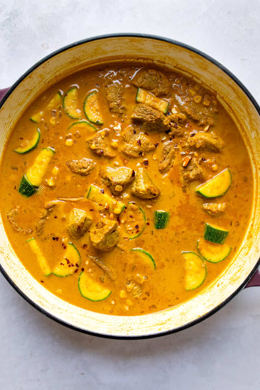 Lean pork loin curry with coconut milk in a pot.