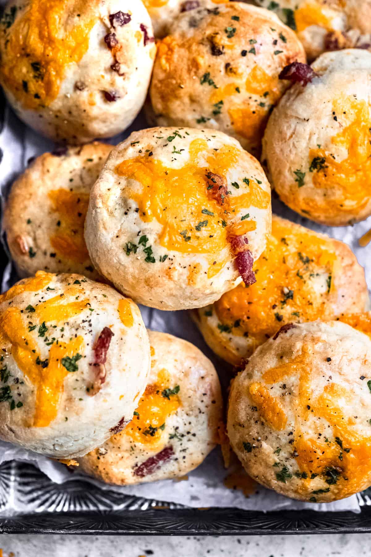 Fluffy cheese and bacon scones on a baking tray.