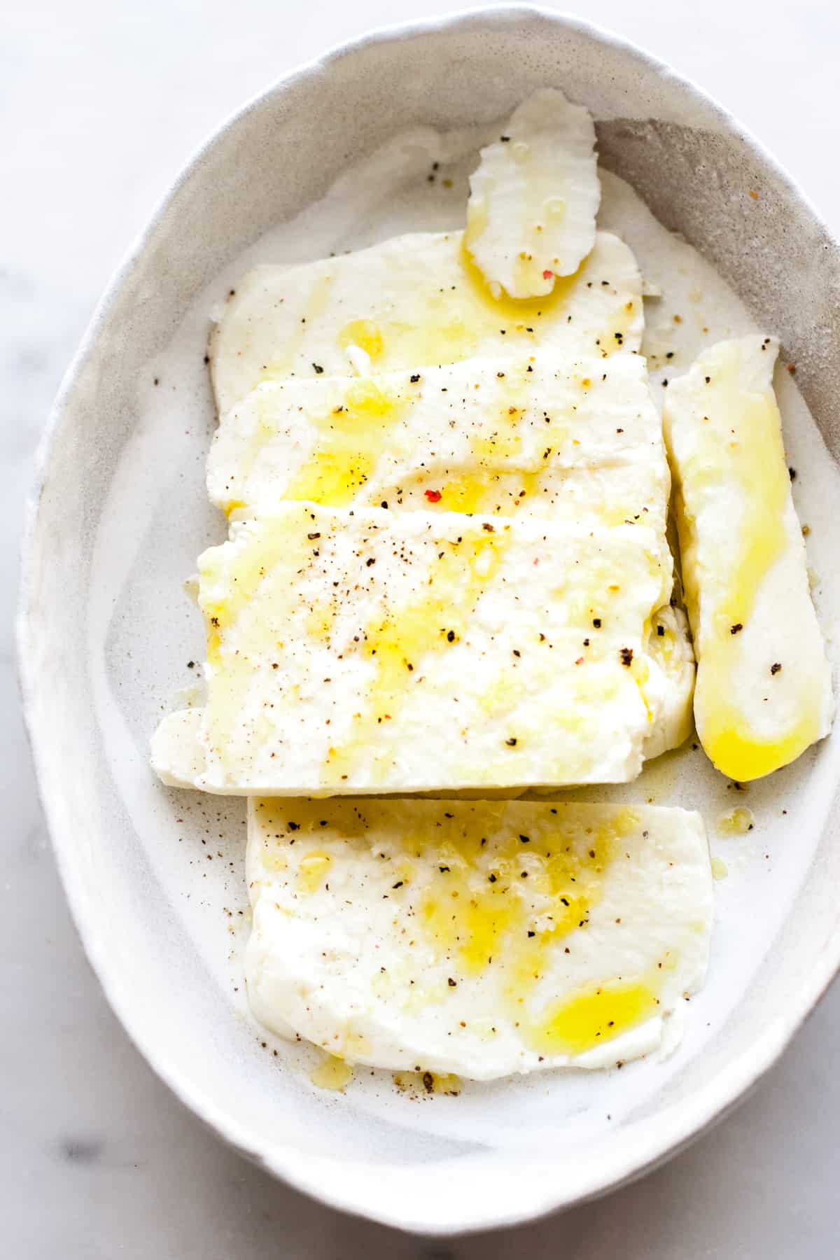 sliced cheese with a drizzle of olive oil