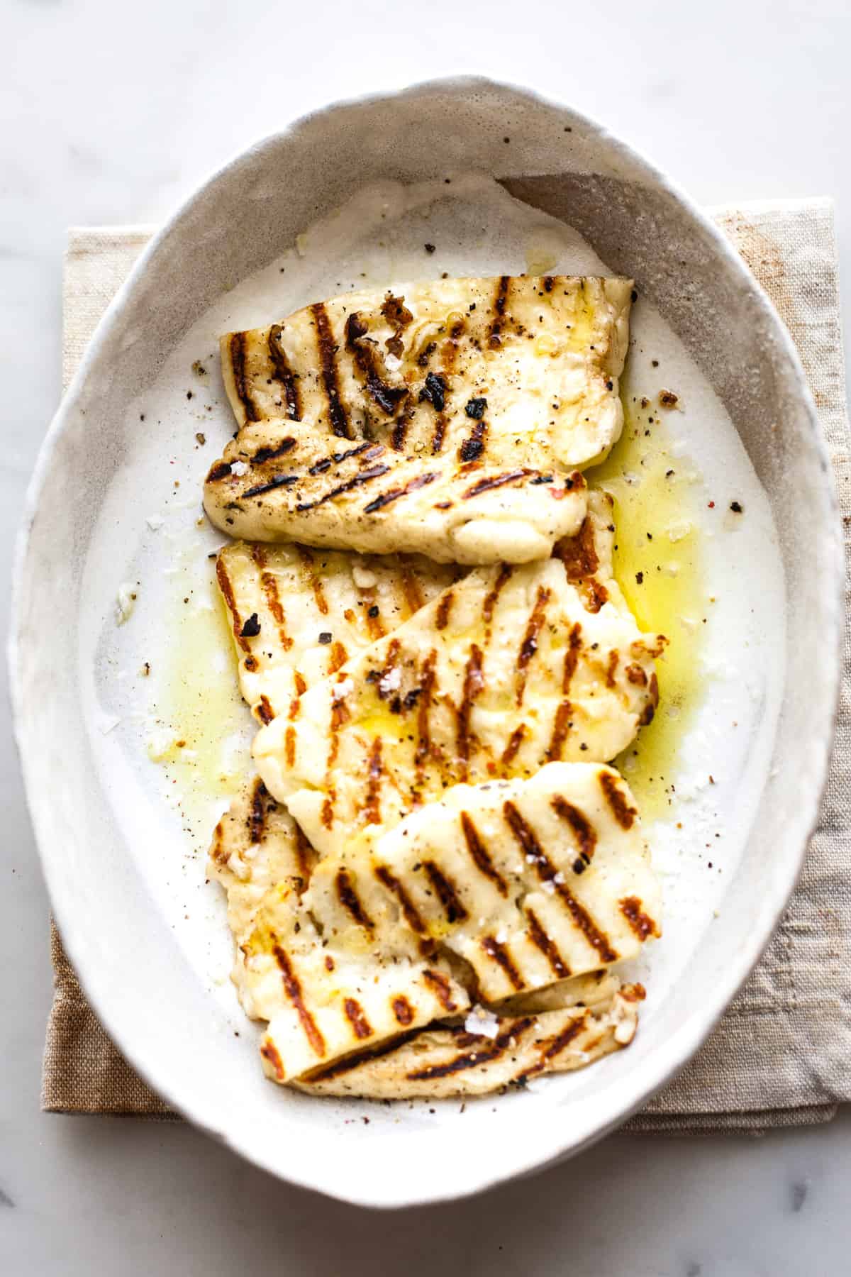 Grilled halloumi in a bowl with sea salt