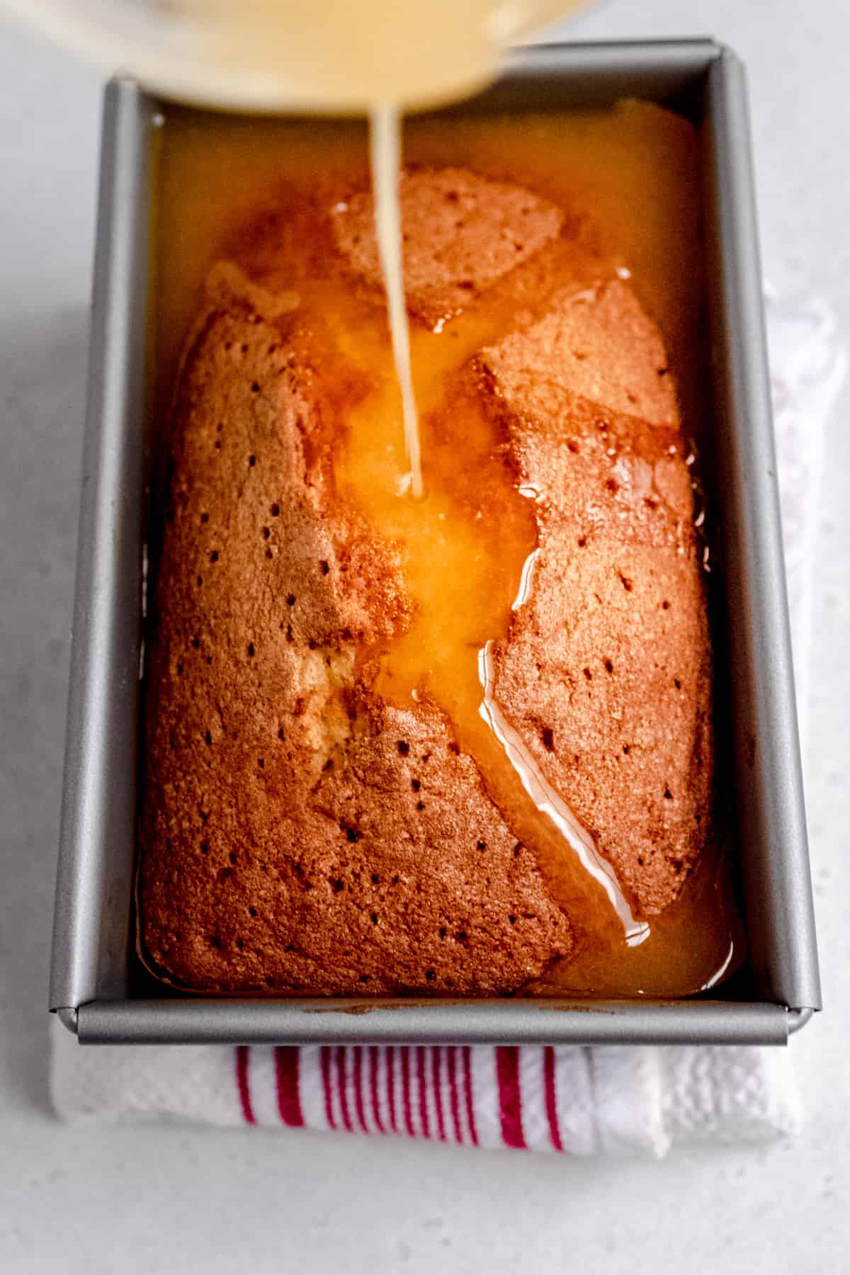 orange drizzle cake with the soaking syrup being added