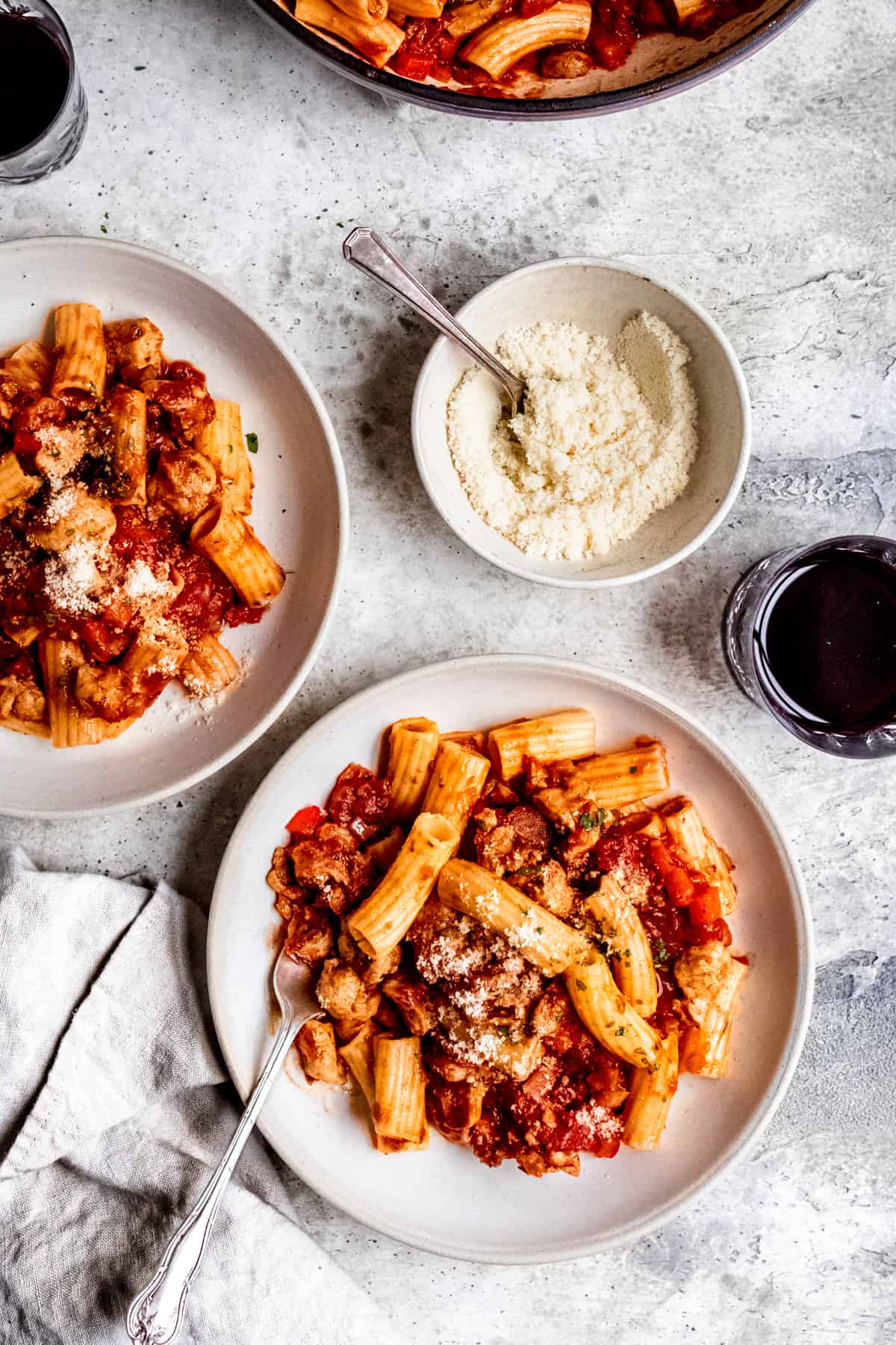 Sausage and pepper pasta in a white bowl