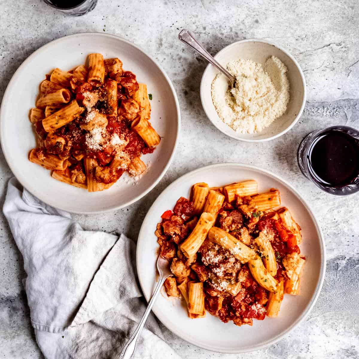 Sausage and pepper pasta in a white bowl