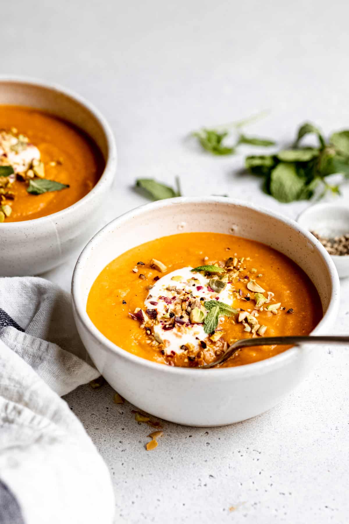 Turkish lentil soup in a white bowl with a spoon. 