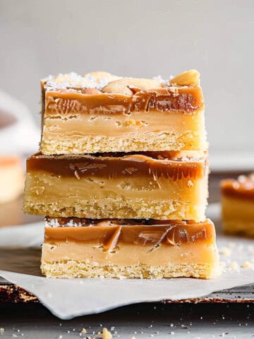 White chocolate millionaire shortbread on a piece of baking paper.