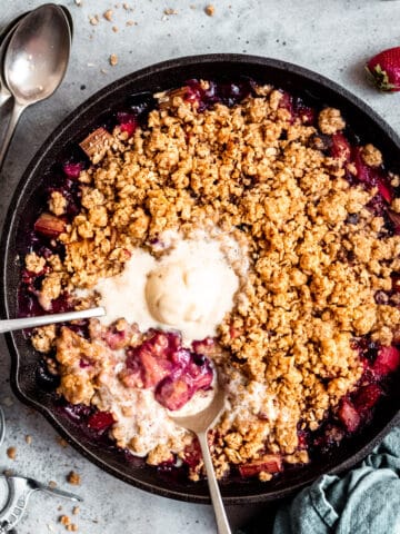 Rhubarb crumble with ice cream and spoons.
