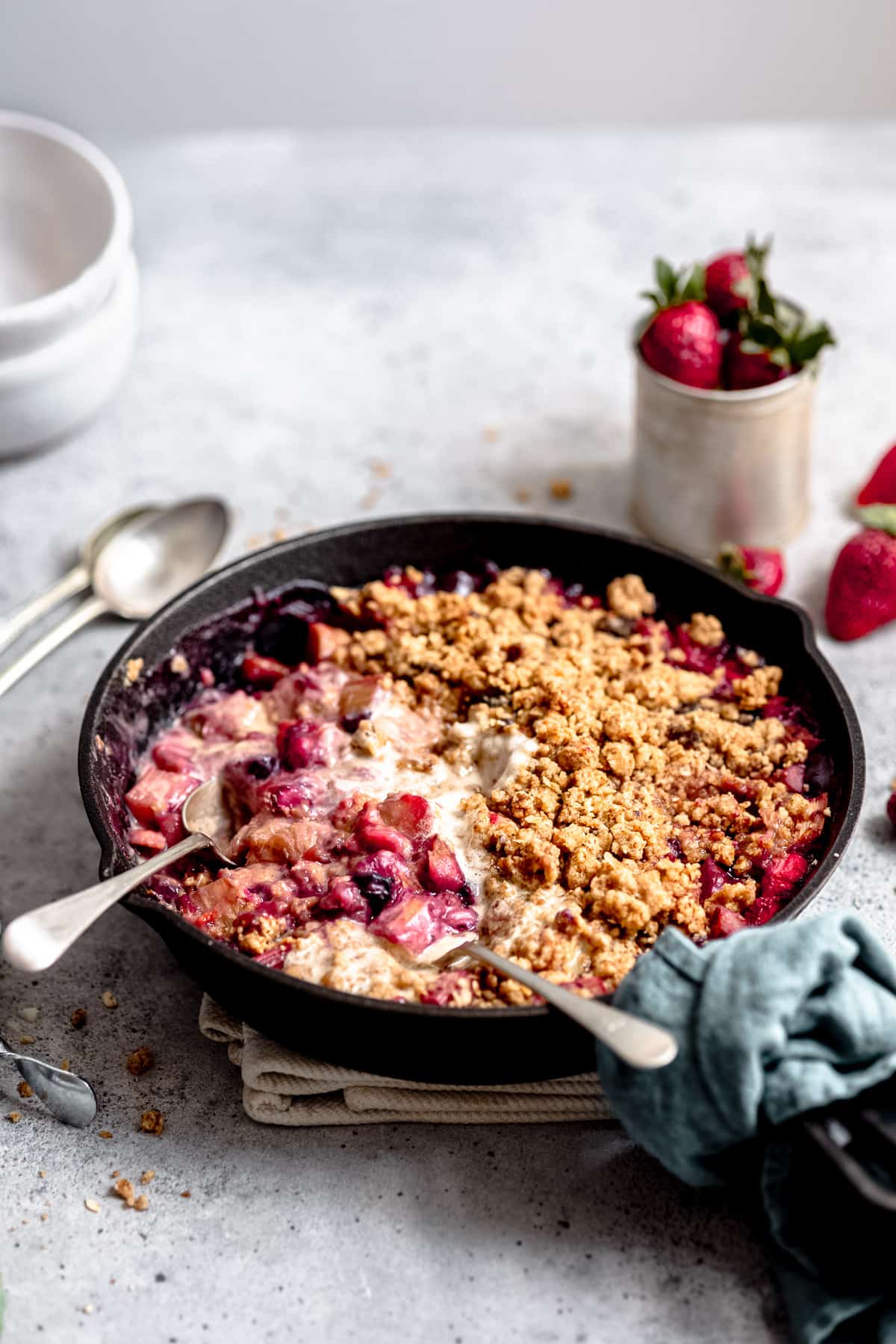 baked rhubarb ginger crumble with ice cream and spoons