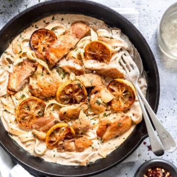 Creamy lemon chicken pasta in a skillet with parsley.