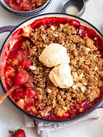 Apple and strawberry crumble in a casserole dish.