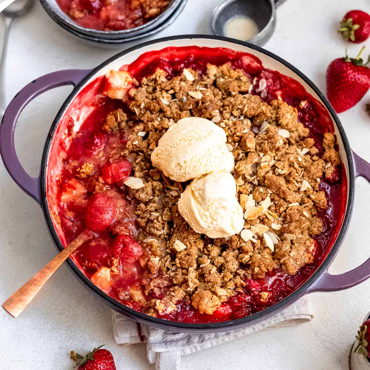 Apple and strawberry crumble in a casserole dish.