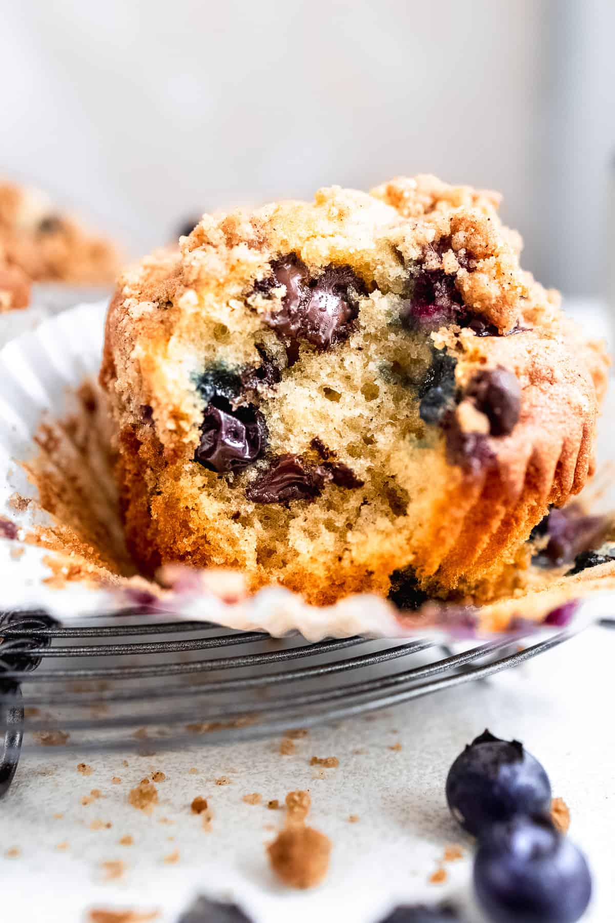 Light and fluffy blueberry chocolate chip muffin in a paper muffin case.