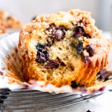 Close up of a blueberry chocolate chip muffins in muffin cases.