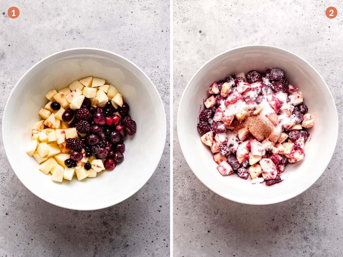 Chopped apples and blackberries in a bowl with sugar.
