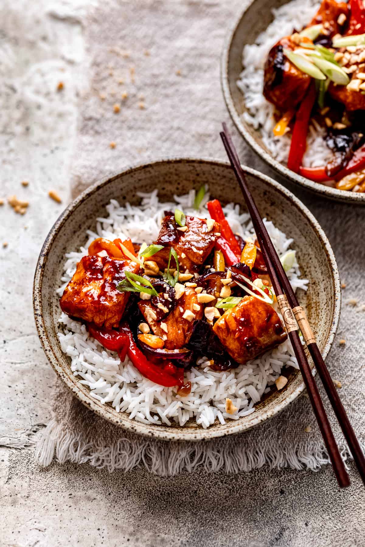 Salmon stir fry in a green bowl.