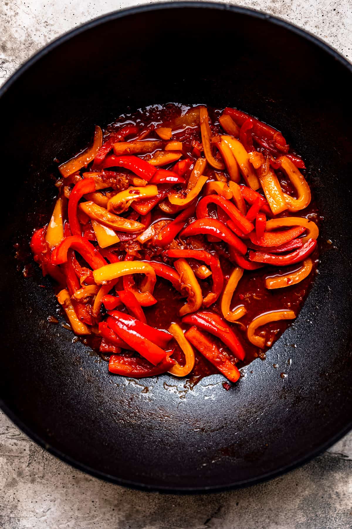 Peppers being sauted in a frying pan.