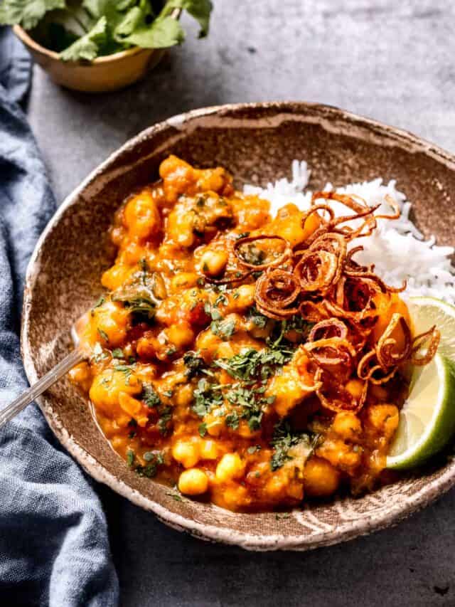 Butternut Squash and chickpea curry with coconut milk and lime wedges