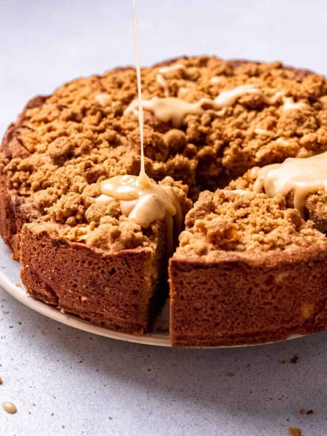Maple glaze being drizzled onto Dorset apple cake.