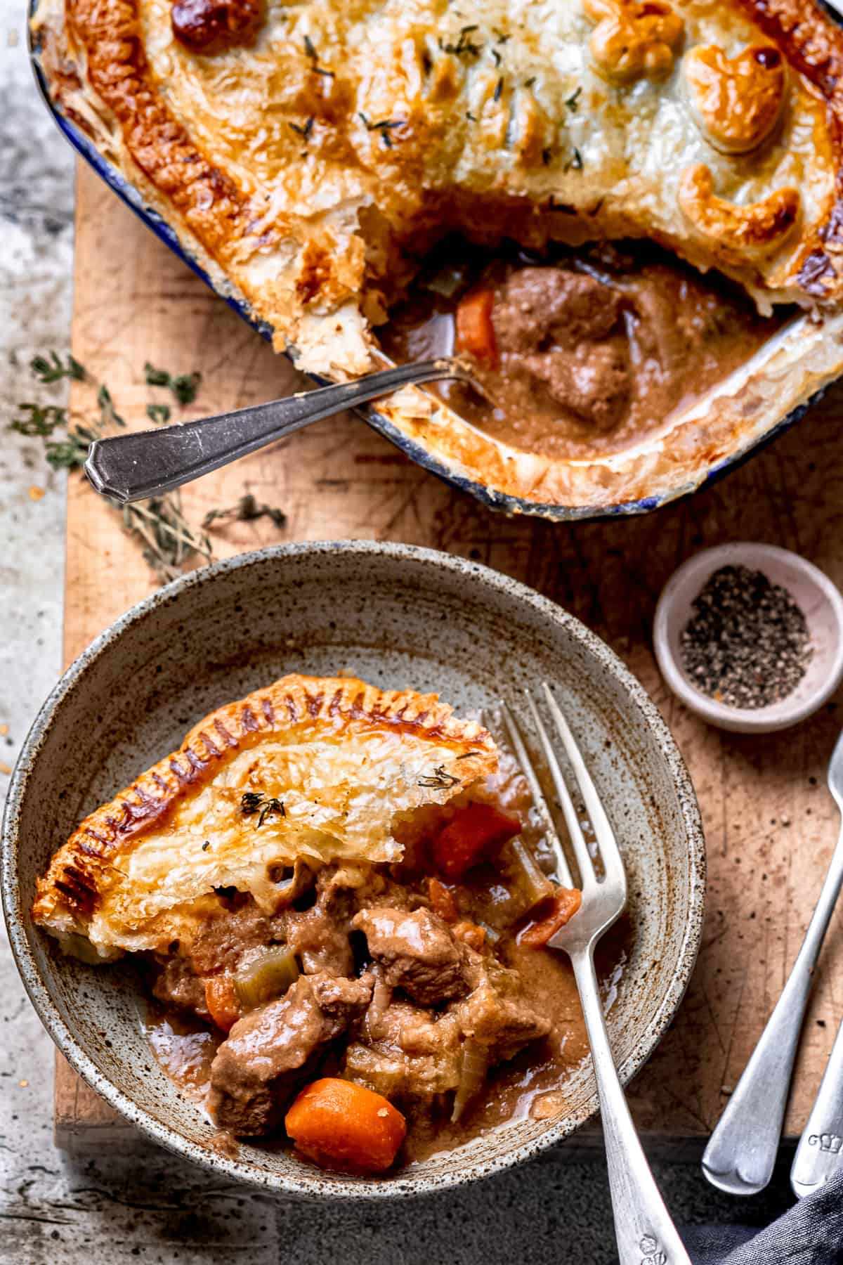 A bowl of slow cooker steak pie with a fork.