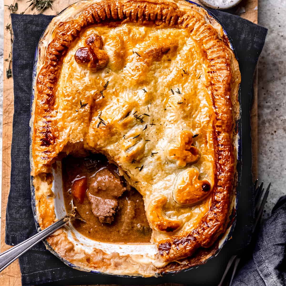 Slow cooker steak pie with a puff pastry lid.