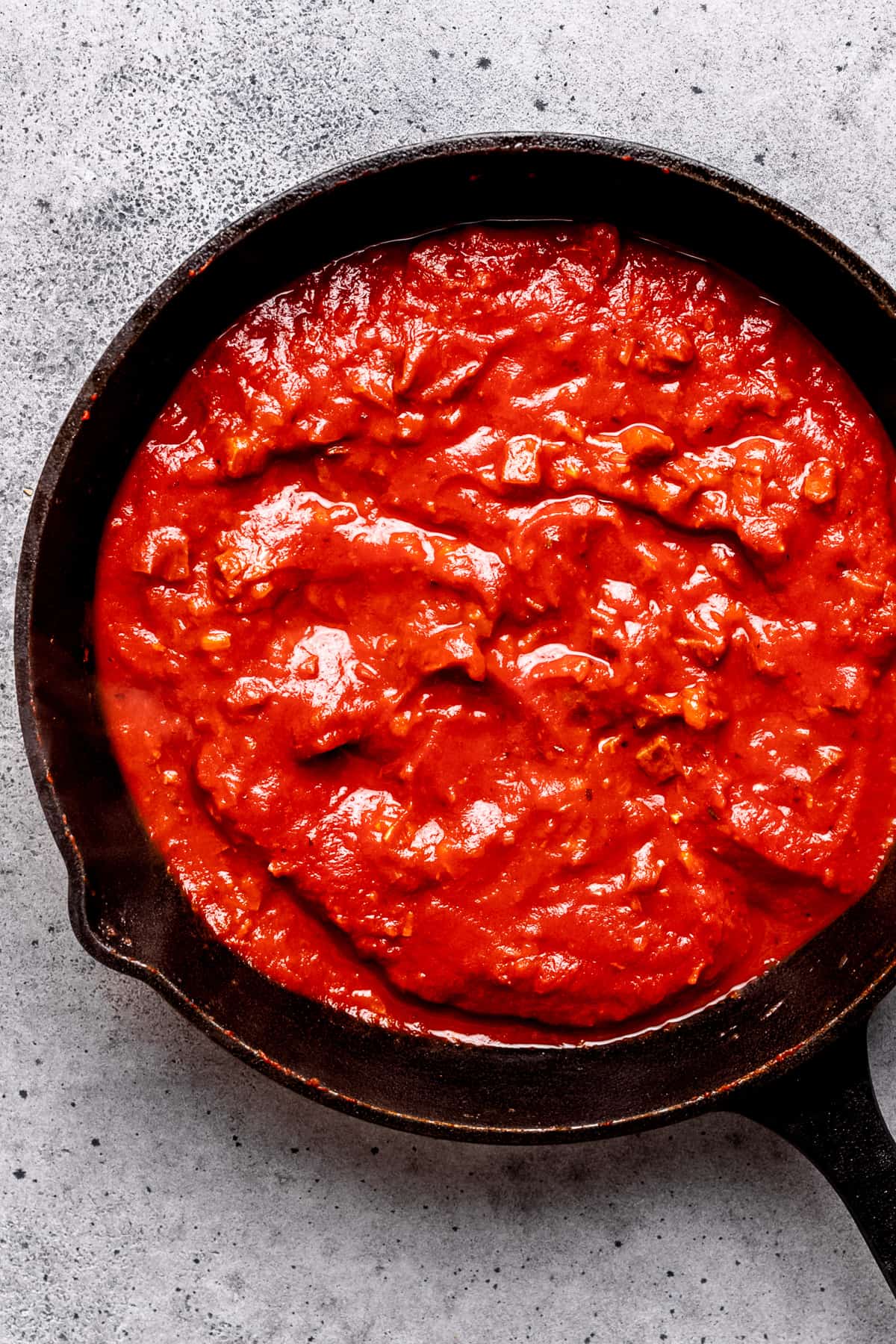 Tomato sauce in a pan with chorizo.