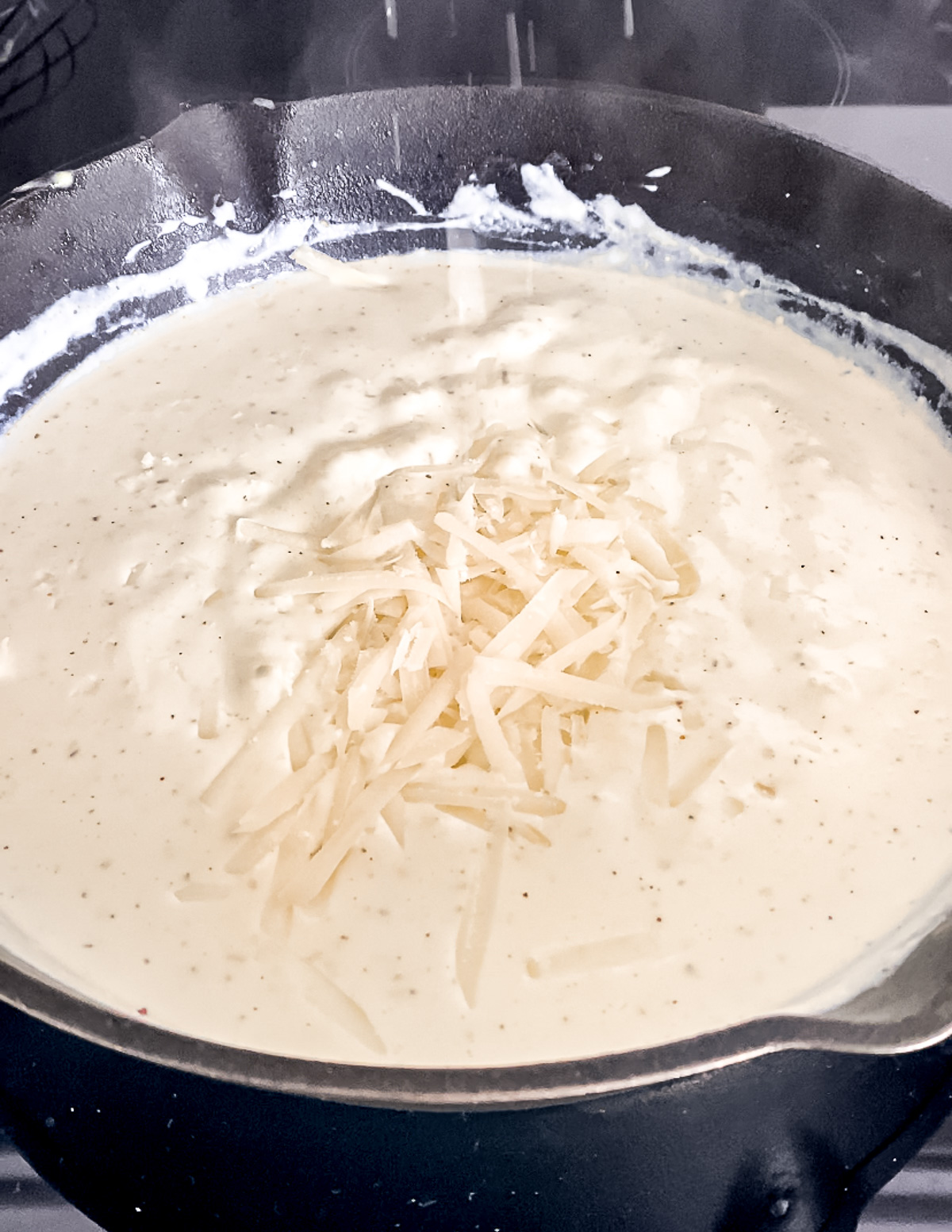 Grated parmesan melting into the sauce.